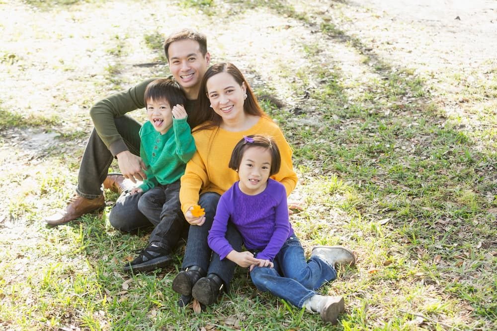 A family enjoying time together outdoors, representing the goal of finding the right home and support